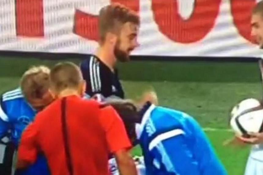 Scotland's James Morrison and Germany's Christoph Kramer sneak in a round of rock-paper-scissors during their countries' Euro 2016 qualifier. -- PHOTO: SCREENGRAB FROM VINE