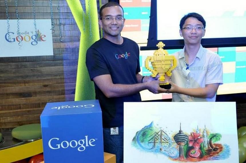 Lee Yee Run, 16, receiving his trophy made out of Lego from Google Malaysia managing director Sajith Sivanandan for his winning doodle, titled Beauty Of Malaysia. -- PHOTO: THE STAR/ASIA NEWS NETWORK&nbsp;