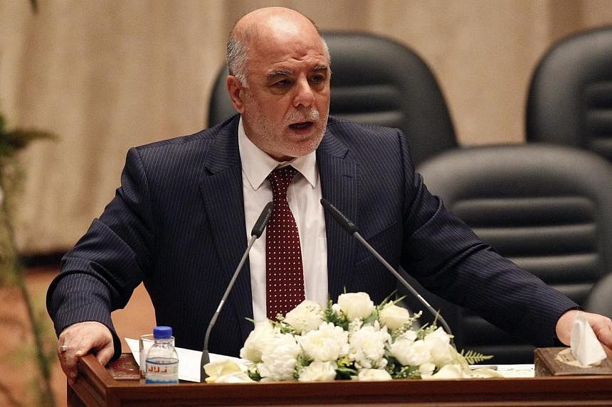 Iraq's new premier Haider Abadi speaks to Iraqi lawmakers before submitting his government at the parliament headquarters in Baghdad, on Sept 8, 2014. -- PHOTO: REUTERS