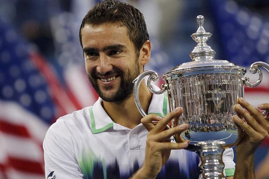 Marin Cilic of Croatia holds his trophy after defeating Kei Nishikori of Japan in their men's singles final match at the 2014 US Open tennis tournament in New York, on Sept 8, 2014. -- PHOTO: REUTERS