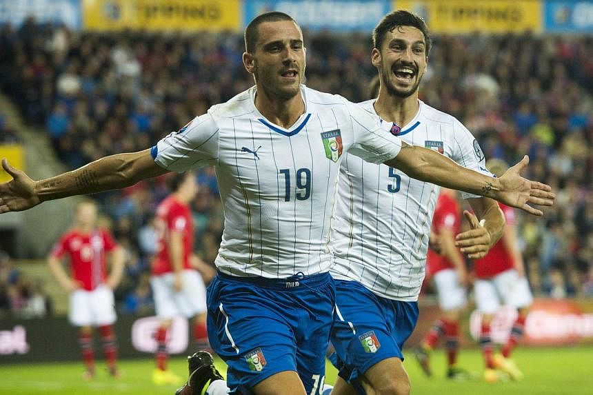talian players Leonardo Bonucci (left) celebrates scoring the 2-0 goal with his teammate Davide Astori during the Uefa Euro 2016 Group H qualifying football match Norway vs Italy in Oslo&nbsp;on Sept 9, 2014. -- PHOTO: AFP