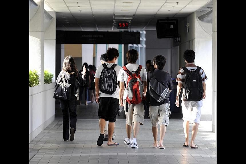 Students, such as these polytechnic students heading to class, should not seek qualifications as a paper chase, says Minister Heng Swee Keat, but rather as a quest for skills. He said the belief that qualifications are all that matter is limiting bec