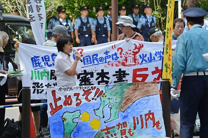 Anti-nuclear demonstrators stage a rally in front of the Nuclear Regulatory Authority (NRA) in Tokyo on September 10, 2014. Japan's nuclear watchdog gave the greenlight for two reactors to restart, one year after the energy-poor country shut down the