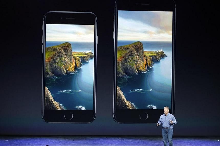 Phil Schiller, Senior Vice President at Apple Inc., speaks about the iPhone 6 (left) and the iPhone 6 Plus during an Apple event at the Flint Center in Cupertino, California on Sept 9, 2014. -- PHOTO: REUTERS