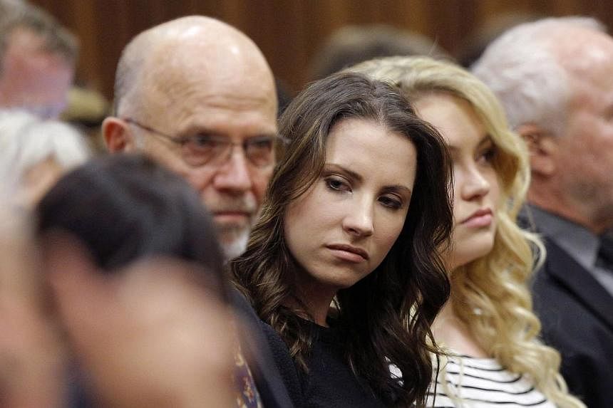 Aimee Pistorius (centre), sister of Oscar Pistorius, sits with family at the North Gauteng High Court in Pretoria&nbsp;on Sept 11, 2014. -- PHOTO: REUTERS