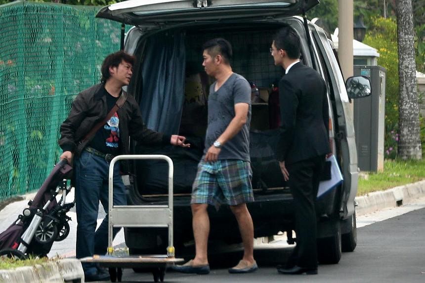 Mr Yang Yin (left) made his first public appearance yesterday when he turned up at the Gerald Crescent bungalow to retrieve his belongings. With him are his lawyer (right) and the driver of the van used to transport the items. -- ST PHOTO: NEO XIAOBI
