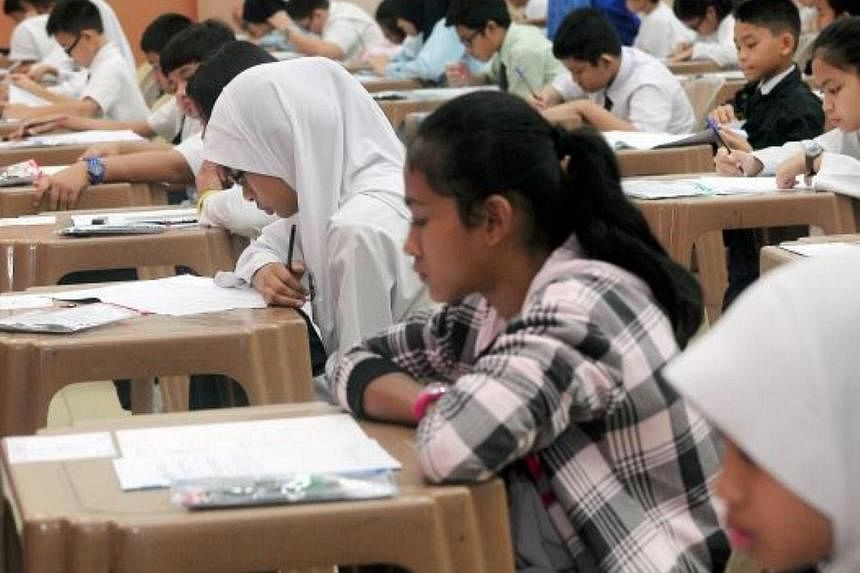 Pupils taking a USPR examination. Malaysia's Education Ministry is grappling with leaks in two papers in the key examination. -- PHOTO: THE STAR/ASIA NEWS NETWORK&nbsp;