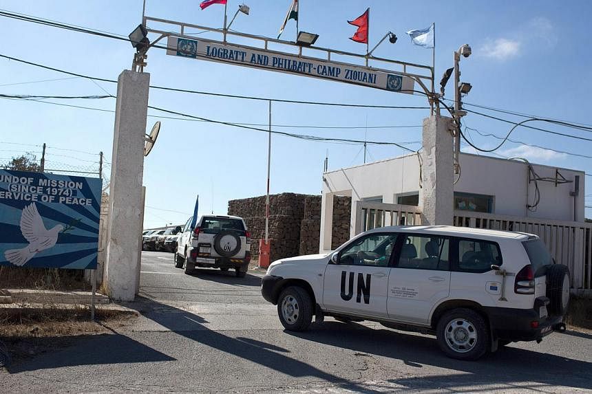 A United Nations Disengagement Observer Force (UNDOF) car enters the UN headquarters, in the demilitarised zone, near the Quneitra border crossing between Syria and the Israeli annexed Golan Heights on Sept 2, 2014. The Syrian affiliate of Al-Qaeda s