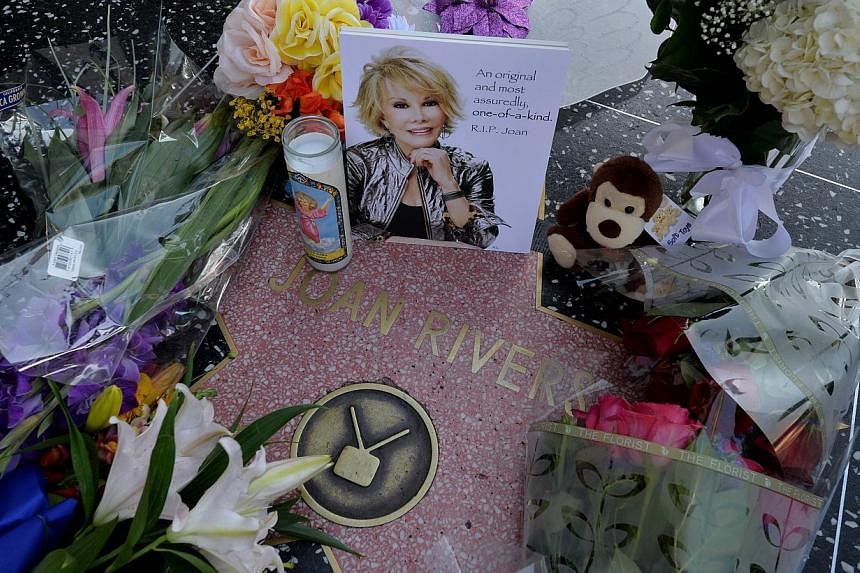 Flowers are placed on the Hollywood Walk of Fame Star for Joan Rivers in Hollywood, California on Sept 4, 2014, following news of the comedian's death in New York at the age of 81.&nbsp;The New York clinic where Rivers stopped breathing a week before