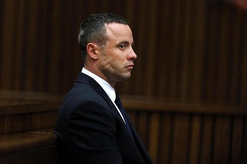 A file picture taken on May 6, 2014 shows South African Paralympic sprinter Oscar Pistorius sitting in the dock during the testimony of a defence witness at his murder trial, accused of murdering his girlfriend Reeva Steenkamp, at the high court in P