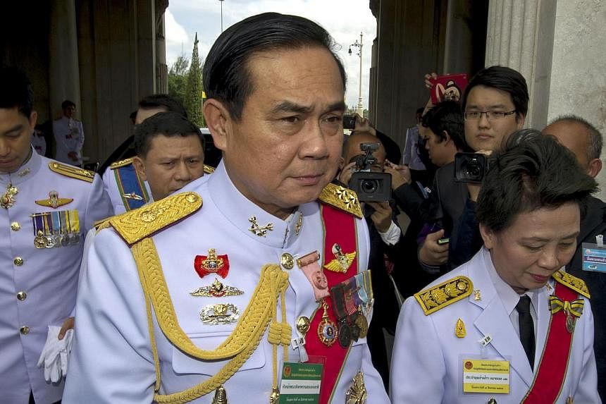Head of the National Council for Peace and Order and army chief General Prayut Chan-O-Cha (centre) upon his arrival prior the opening of the National Legislative Assembly in Bangkok on Aug 7, 2014. &nbsp;-- PHOTO: AFP