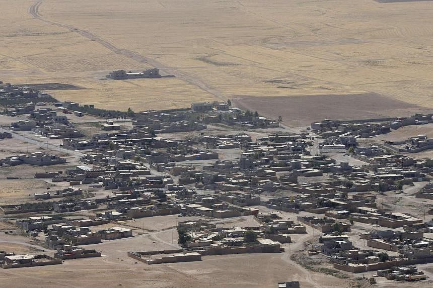 A general view shows Baretle village, which is controlled by the Islamic State (IS), in Khazir, on the edge of Mosul Sept 8, 2014. IS militants in Iraq and Syria now have about 20,000 to 31,500 fighters on the ground, says the CIA. -- PHOTO: REUTERS