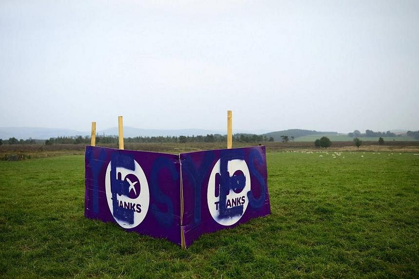 A "No" campaign poster is seen in a field after being vandalised by a "Yes" supporter on the outskirts of Edinburgh, Scotland, on Sept 11, 2014. -- PHOTO: REUTERS
