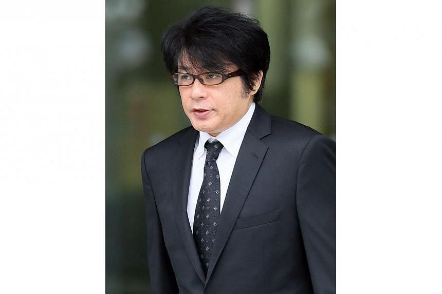 Japanese pop singer Aska, who was released on bail at a Tokyo police station on July 3, 2014.&nbsp;He was convicted on Friday of using illegal drugs in his apartment in Tokyo, and was handed a suspended jail sentence. -- PHOTO: AFP