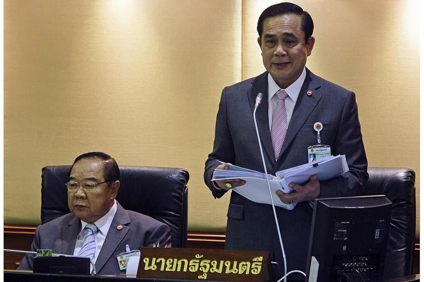 Thailand's Prime Minister Prayuth Chan-ocha (right) reads out his government's policy, as Deputy Prime Minister and Defence Minister Prawit Wongsuwan listens, at the Parliament in Bangkok on Sept 12, 2014.&nbsp;-- PHOTO: REUTERS