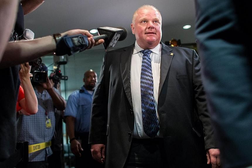 This June 30, 2014 file photo shows Toronto Mayor Rob Ford leaving his office amid a crush of cameras at city hall in Toronto, Canada.&nbsp;Ford on Thursday transferred hospitals via ambulance to a facility specializing in cancer treatment, a day aft