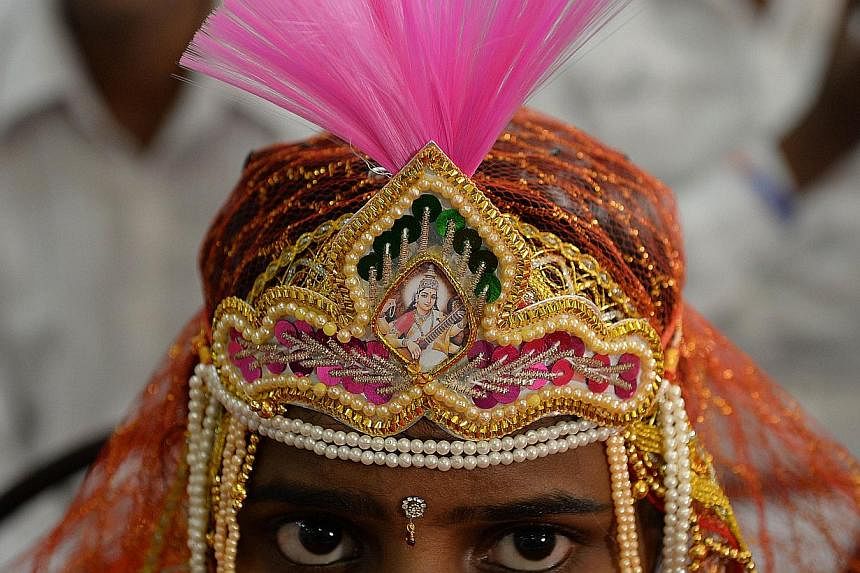 An Indian Hindu bride looking on during a multifaith mass wedding in Mumbai on June 22, 2014. -- FILE PHOTO: AFP&nbsp;