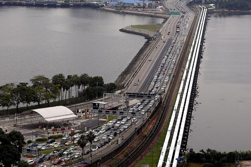 Singapore will revise its toll charges at the Causeway to match those of Malaysia. -- PHOTO: ST FILE