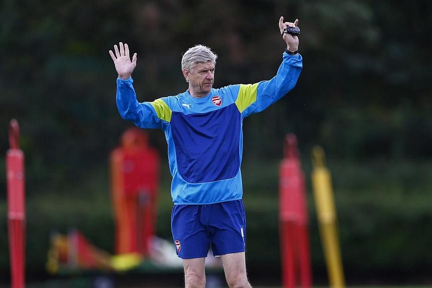 Arsenal manager Arsene Wenger attends a team training session at their training ground in London Colney, north of London, Aug 18, 2014.&nbsp;Wenger believes Arsenal have a golden opportunity to underline their title credentials when they host champio