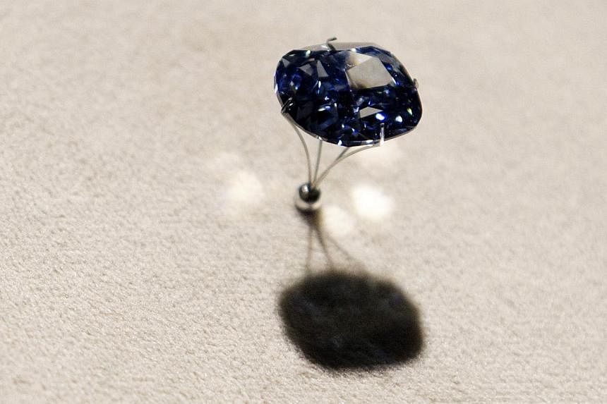 A 12-carat "Blue Moon Diamond" is pictured while on display at the Natural History Museum of Los Angeles County in Los Angeles, California on Sept 12, 2014. -- PHOTO: REUTERS