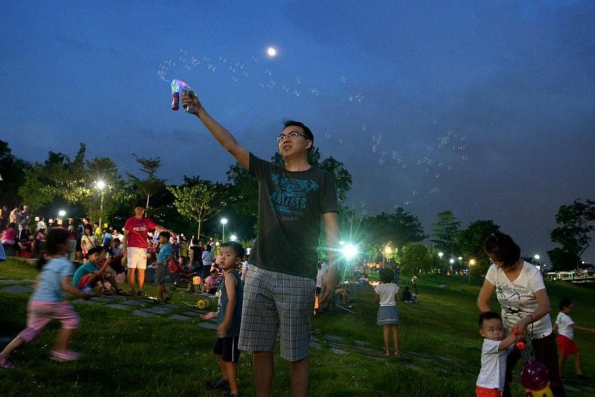 Families enjoying themselves at a Mid-Autumn Festival event. Sociologist Tan Ern Ser says younger children may need more attention, both in terms of quality and quantity, while teens may not need as much "quantity time".