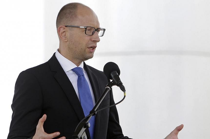 Ukrainian Prime Minister Arseniy Yatsenyuk on Saturday accused Russian President Vladimir Putin of wanting to wipe out Ukraine as an independent country despite a truce deal. -- PHOTO: REUTERS