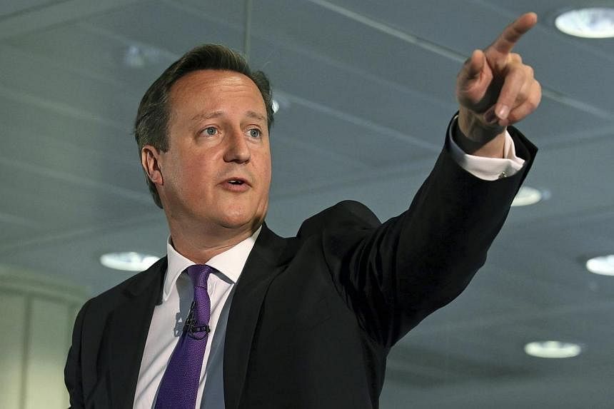 Britain's Prime Minister David Cameron gestures as he speaks during a visit to the Scottish Widows building in Edinburgh, Scotland on Sept 10, 2014. -- PHOTO: REUTERS
