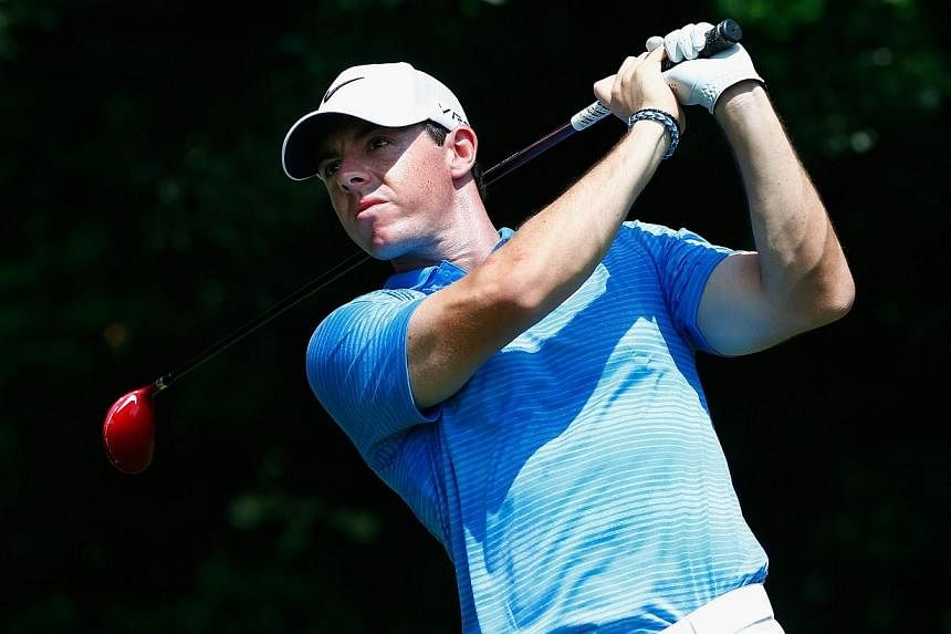 Rory McIlroy of Northern Ireland hits his tee shot on the third hole during the third round of the TOUR Championship by Coca-Cola at the East Lake Golf Club on Sept 13, 2014 in Atlanta, Georgia. -- PHOTO: AFP