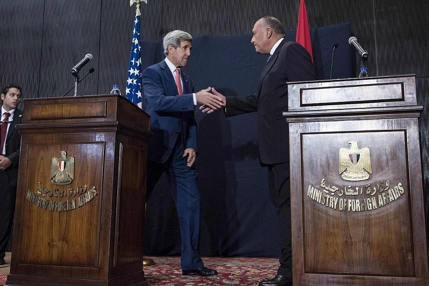 US Secretary of State John Kerry shakes hands with Egyptian Foreign Minister Sameh Shoukry (right) at the end of a joint news conference in Cairo on Sept 13, 2014.&nbsp;US Secretary of State John Kerry said in remarks aired on Sunday he is "extremely