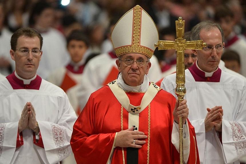 Pope Francis leaves at the end of a mass and the celebration on several weddings at St Peter's basilica on Sept 14, 2014 at the Vatican.&nbsp;Pope Francis married 20 couples on Sunday, some of whom had already lived together and had children, in the 