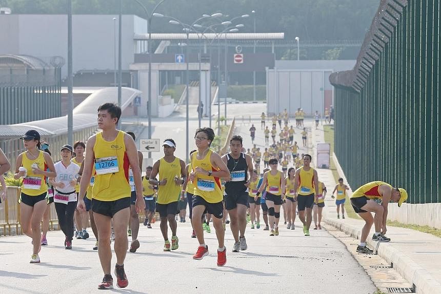Participants running inside the Changi Prison Complex near to the finishing line of the 10km route during&nbsp;the sixth Yellow Ribbon Prison Run on Sunday, Sept 14, 2014. -- ST PHOTO:&nbsp;SEAH KWANG PENG