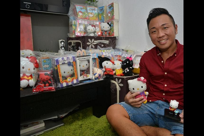 Bank service manager Daniel Lau (above), 28, a bachelor, owns more than 40 Hello Kitty plush toys and figurines. -- ST PHOTO: BENSON ANG