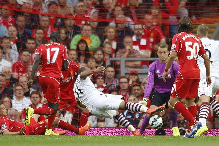 Aston Villa's Gabriel Agbonlahor (centre) scores a goal during their English Premier League soccer match against Liverpool at Anfield in Liverpool, northern England on Sept 13, 2014. -- PHOTO: REUTERS