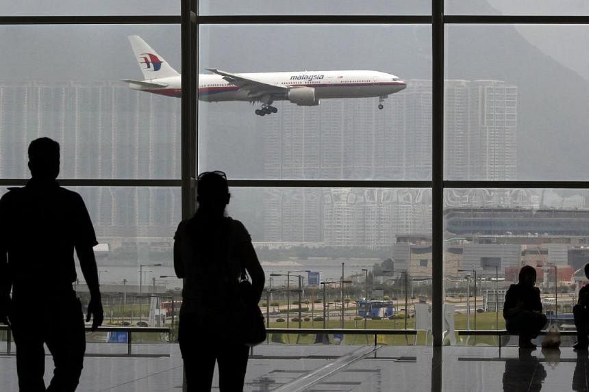 A Malaysia Airlines Boeing 777 plane is seen from the departure hall at the Hong Kong International Airport, in this June 2, 2011 file photo. -- PHOTO: REUTERS