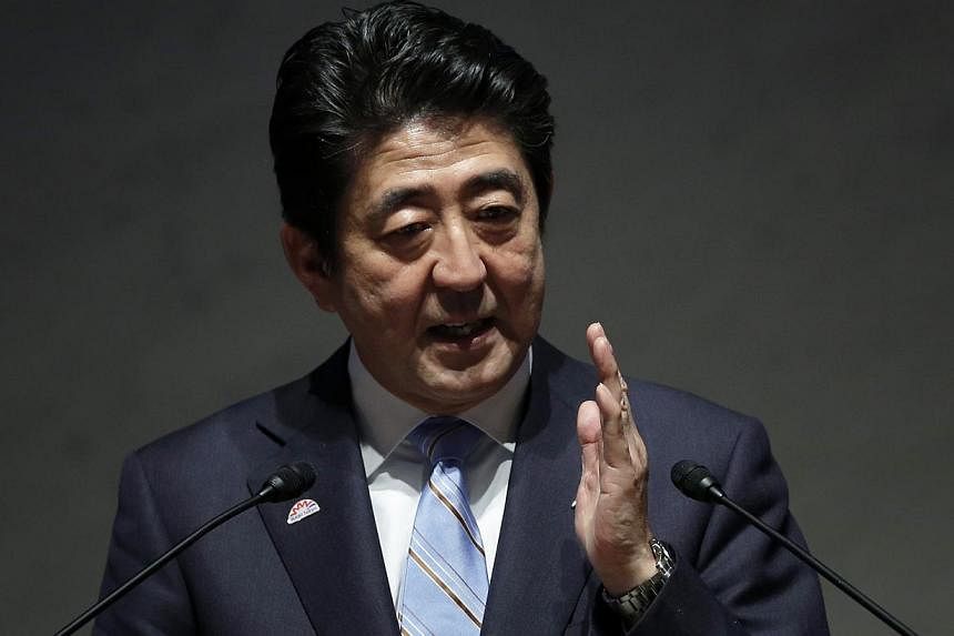 Japanese Prime Minister Shinzo Abe said on Sunday he remained "neutral" on whether to proceed with a hike in Japan's sales tax to 10 per cent, adding that decision would hinge on the strength of economic indicators for the current quarter. -- PHOTO: 