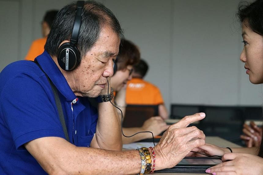 More than 100 elderly from various community centres across Singapore including Rogers Luo, 75, undergo free hearing screening at the Siemens Hearing Awareness Week event held at the National University Health System (NUHS) &nbsp;-- ST PHOTO: SEAH KW