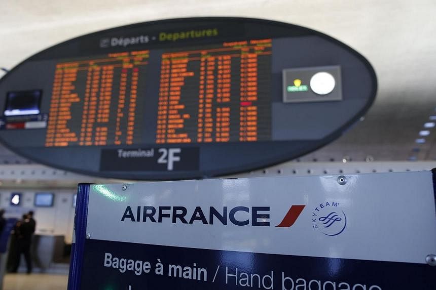 This photo shows the Air France check-in hall and a departing flight timetable at the 2F terminal of Paris-Charles de Gaulle airport in Roissy, north of Paris, on Sept 15, 2014. -- PHOTO: AFP