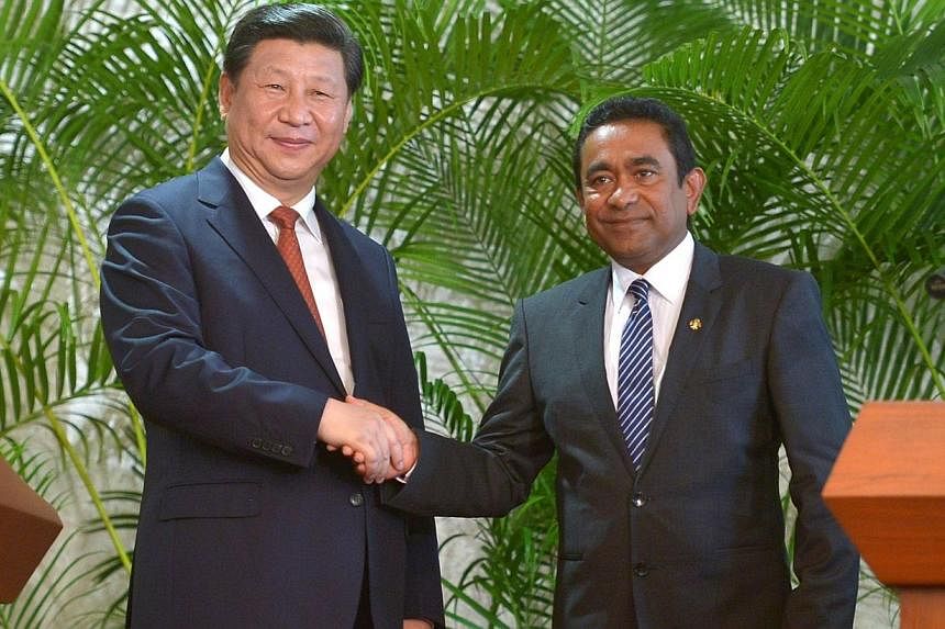 Visiting Chinese President Xi Jinping (left) shakes hands with Maldives President Abdulla Yameen at the President’s Office in the capital island Male on Sept 15, 2014. -- PHOTO: AFP