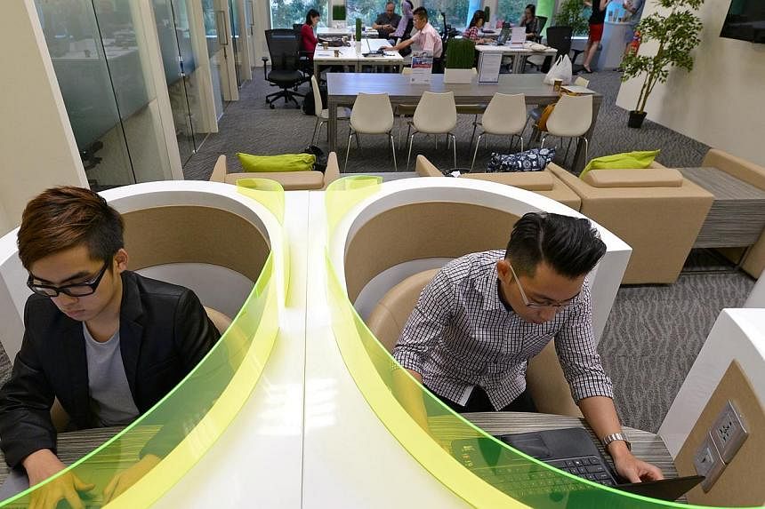Start-up owners Alex Yeo (right), 31, and Shawn Lau, 19, like working from the smart work centres at three community libraries because of their convenient locations and conducive environment.