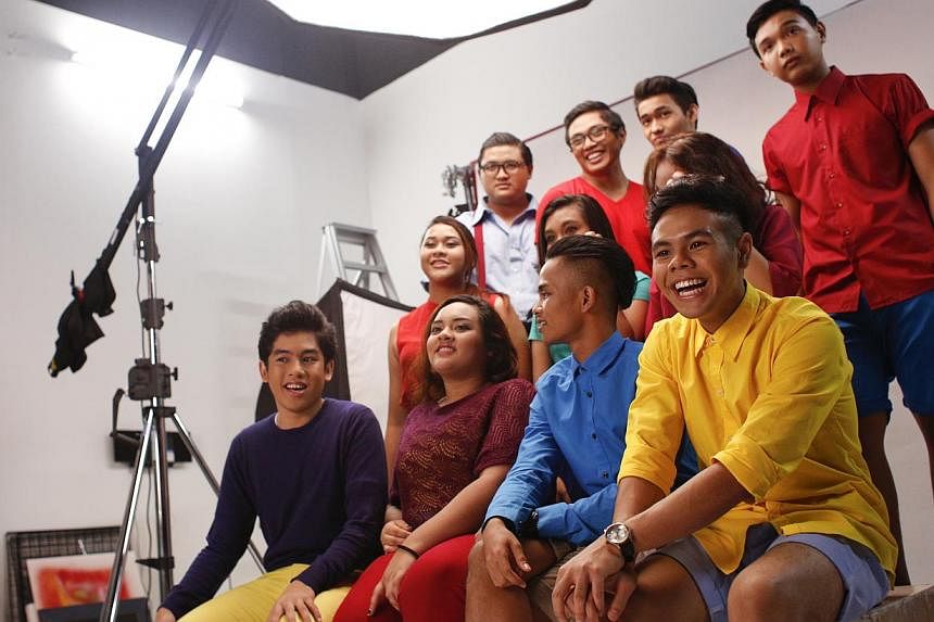 Students from the ITE show choir pose for photographs during a photography session for the ChildAid 2014 programme booklet on Sept 11, 2014. -- ST PHOTO: DESMOND LUI