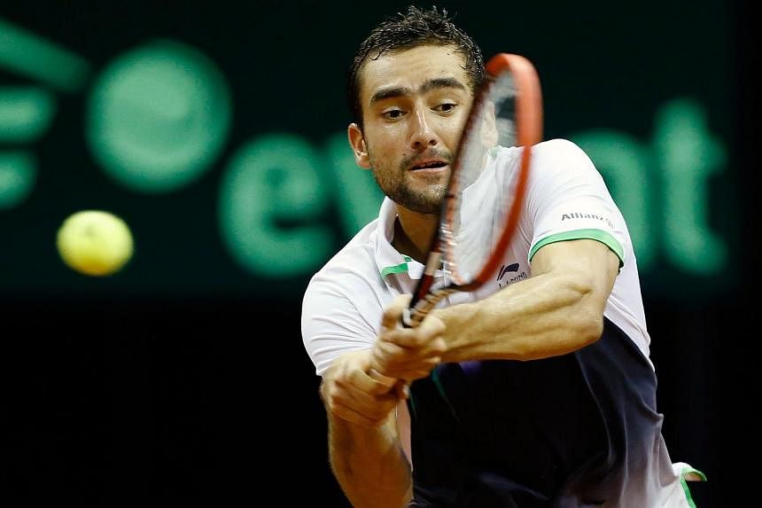 Croatia's Marin Cilic returns a backhand to Dutch player Thiemo de Bakker during their Davis Cup World Group play-off tennis match at the Ziggo Dome in Amsterdam, on Sept 14, 2014. -- PHOTO: AFP&nbsp;