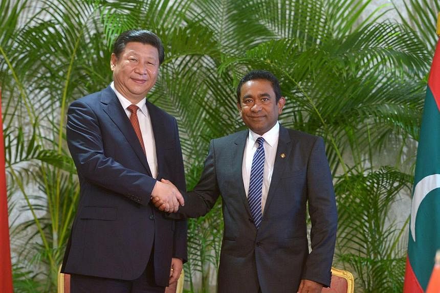 Visiting Chinese President Xi Jinping (left) shakes hands with Maldives President Abdulla Yameen at the President’s Office in the capital island Male on Sept 15, 2014. -- PHOTO: AFP