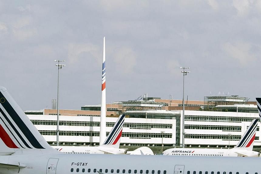 A picture taken on September 15, 2014 shows Air France aircraft at the Paris-Charles de Gaulle airport in Roissy, north of Paris. -- PHOTO: AFP