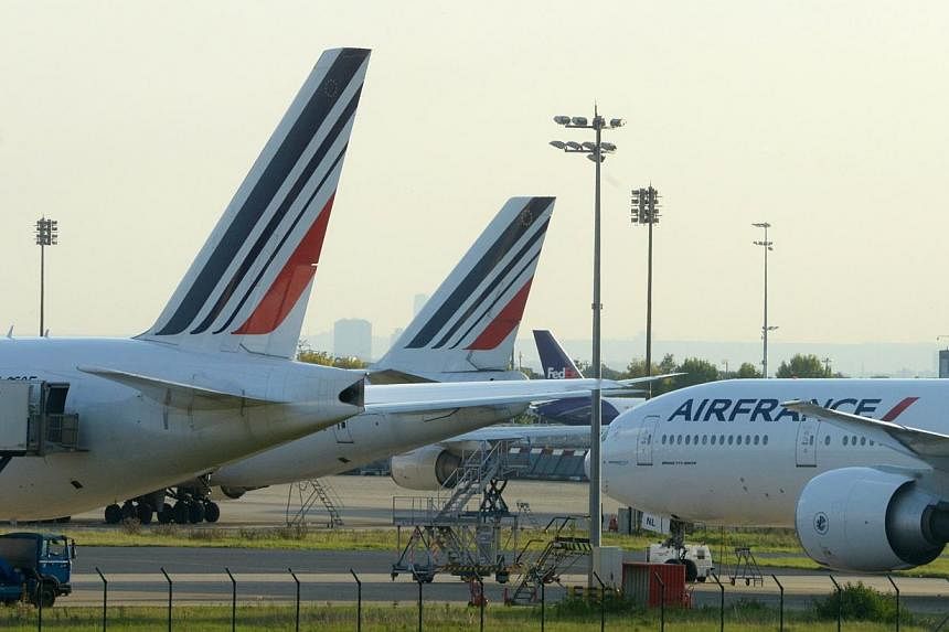 Planes parked on the tarmac of Roissy Charles de Gaulle's airport, during the first day of the French company Air France pilots' strike on Sept 15, 2012. -- PHOTO: AFP