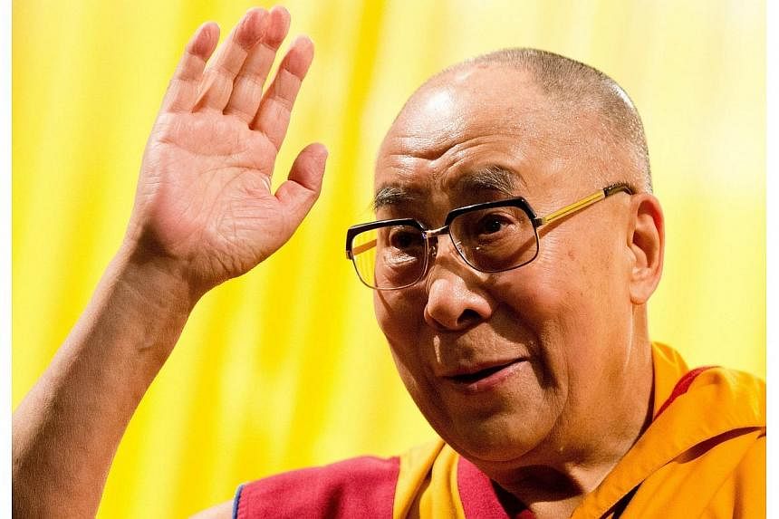 Tibetan spiritual leader Dalai Lama gestures during a lecture entitled "Living wisely and compassionately – Lectures about Buddhism" in Hamburg, northern Germany on Aug 25, 2014. -- PHOTO: AFP
