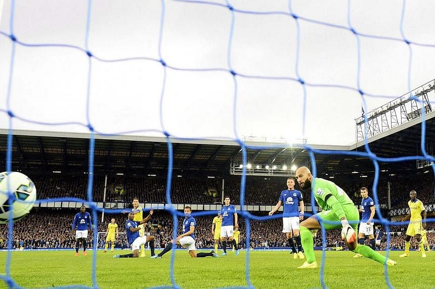 Chelsea's Nemanja Matic (fourth, left) scores a goal against Everton during their English Premier League soccer match at Goodison Park in Liverpool, northern England on Aug 30, 2014. -- PHOTO: REUTERS