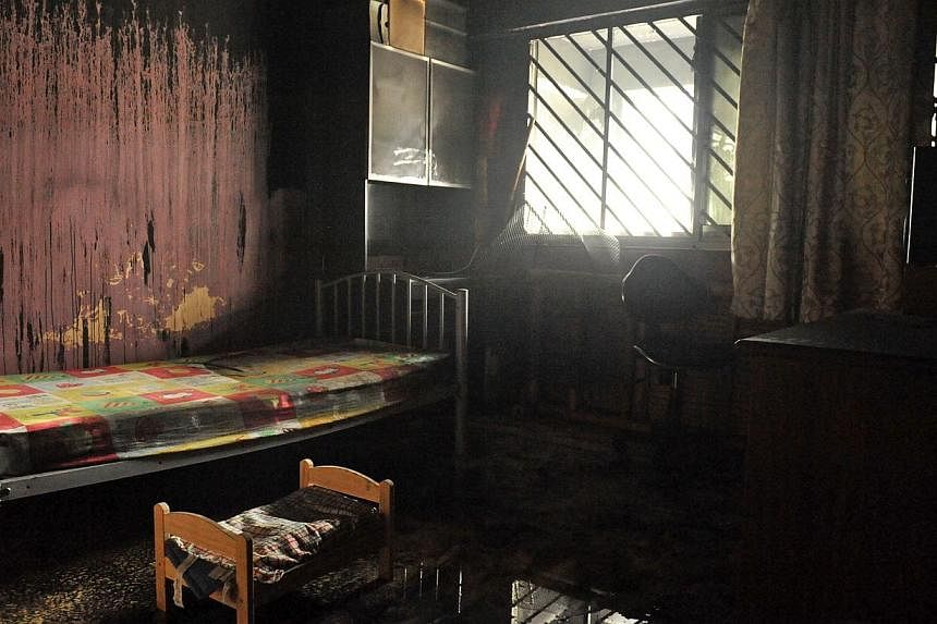 The children's bedroom, which was damaged by the fire. A woman and her five-year-old daughter were treated at National University Hospital for smoke inhalation after their flat in Petir Road caught fire yesterday. -- ST PHOTO: RUDY WONG