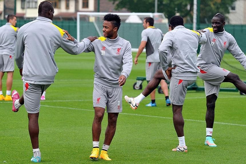 The Liverpool squad stretch during a training session at their Melwood training ground in Liverpool, north-west England, on Sept 15, 2014, ahead of their Uefa Champions League match against Ludogorets at Anfield. -- PHOTO: AFP