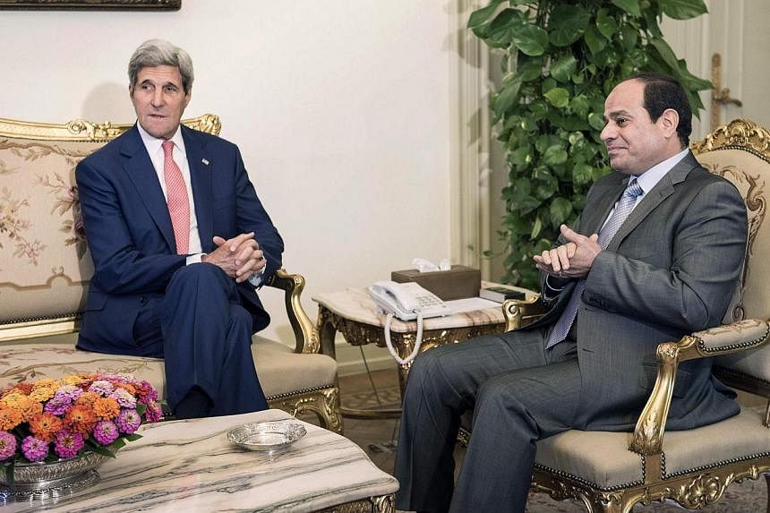 US Secretary of State John Kerry (left) listens while Egyptian President Abdel Fattah al-Sisi talks before a meeting at the presidential palace in Cairo on Sept 13, 2014. Washington said countries in the Middle East had offered to join air strikes ag