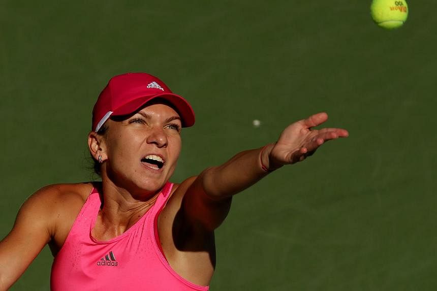 World No. 2 Simona Halep has become the third player to book her place at the WTA Tour's season ending Finals tournament in Singapore next month. -- PHOTO: AFP